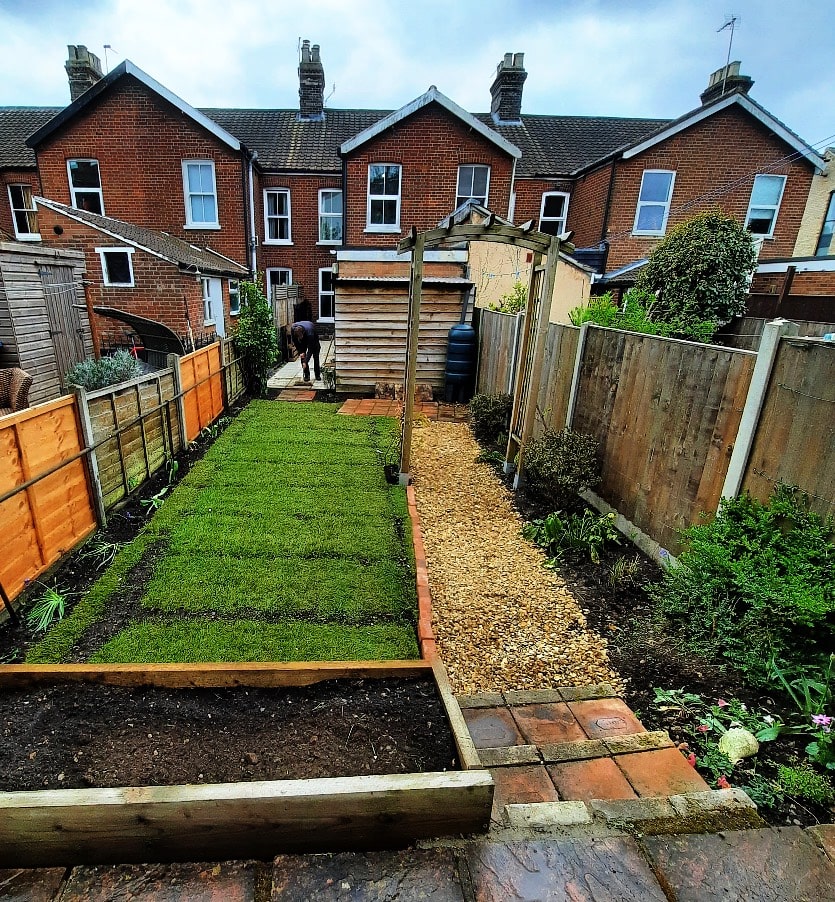 arch walkway and laying turf in small city garden